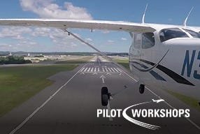Airplane flying near runway on sunny day